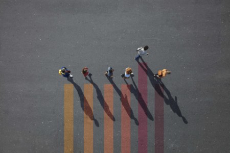 EY - People walking in line on bar chart painted on asphalt