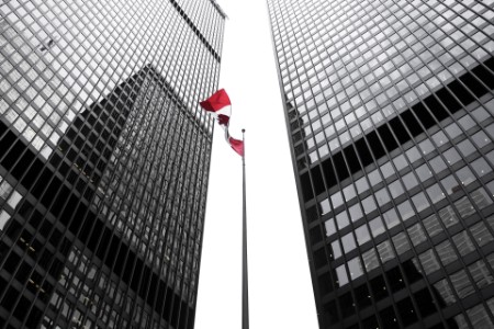 EY - Canada flag amongst office buildings